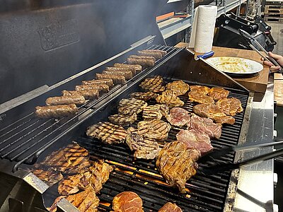 Präzision trifft BBQ Veranstaltung - Grill mit Grillfleisch und Würstl 